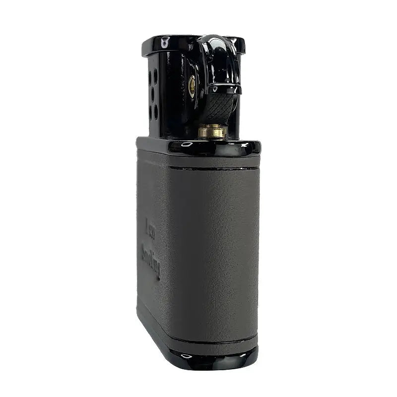 A close-up side view of a gray Thorens cowhide lighter, focusing on the textured mechanical flint wheel and the polished black wind guard.