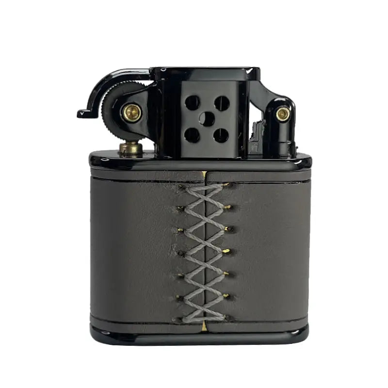 A side profile of a Thorens handmade cowhide lighter in gray, with distinct hand-stitched details and a black metal mechanical head.
