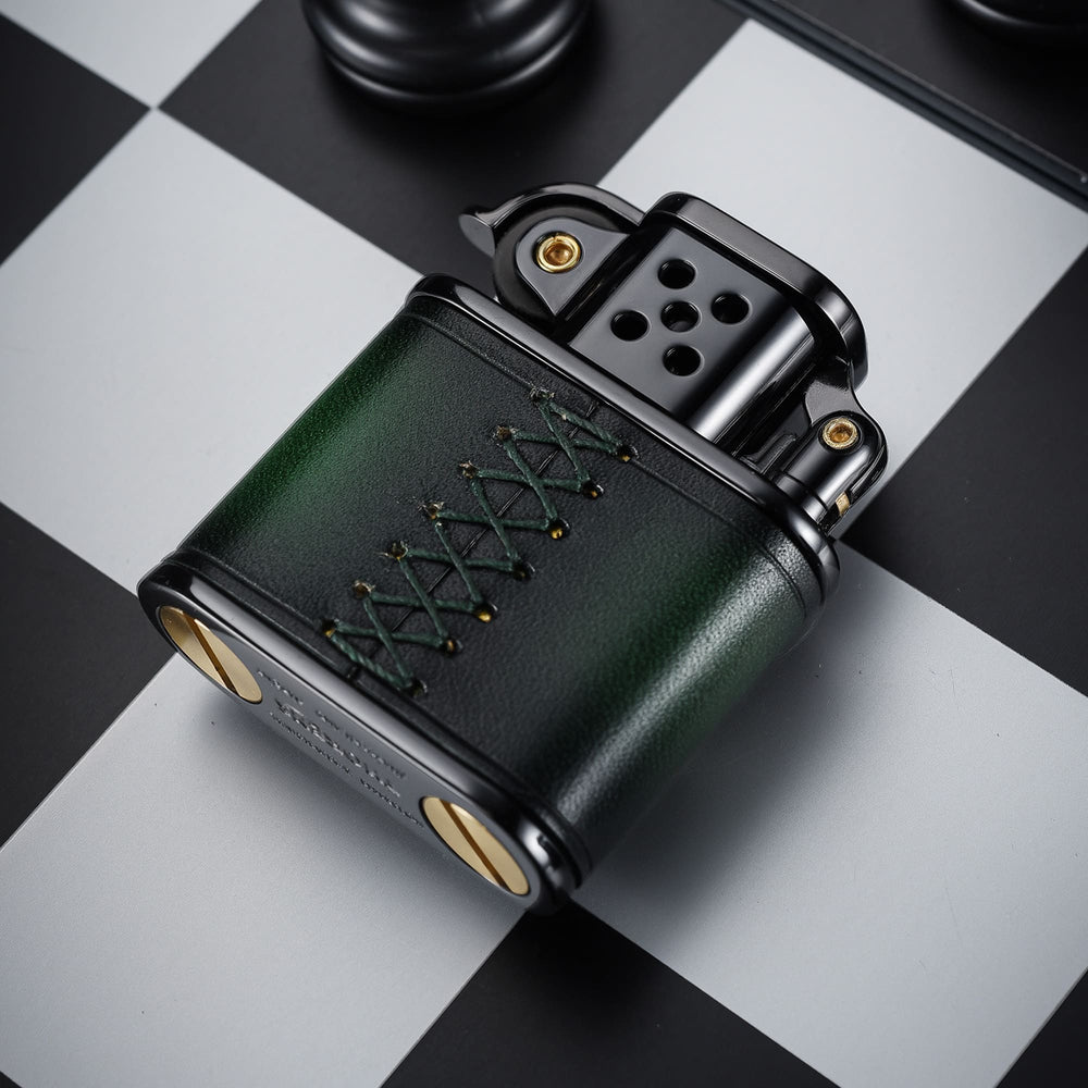 Thorens handmade cowhide lighter in green and black shown from the back, highlighting the stitched leather panel, black metal top, and brass base screws.