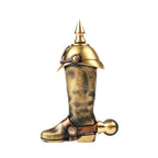 A mechanical knight's boot lighter featuring a spiked helmet lid and spur detail, crafted from weathered antique brass with a textured finish.