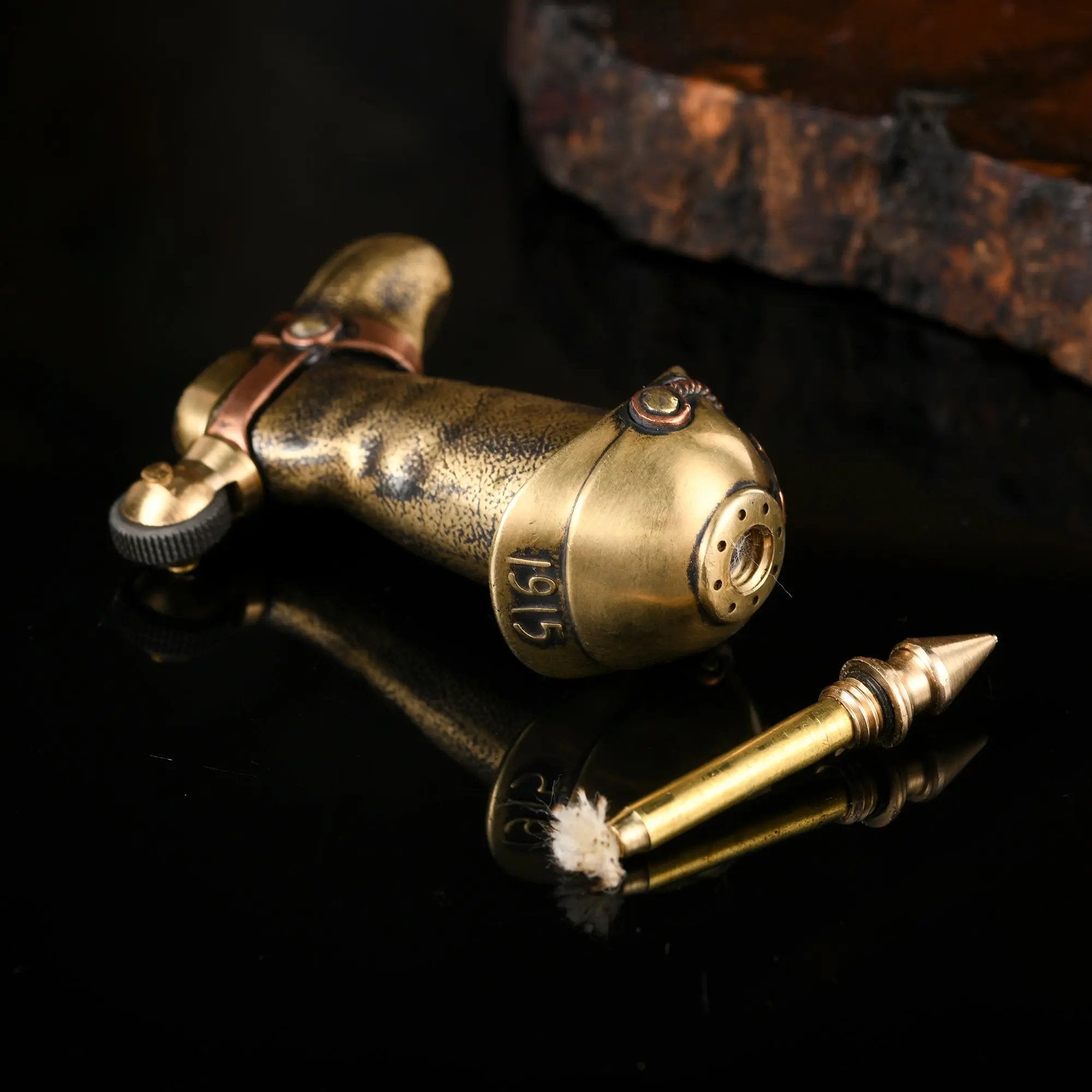 A close-up of the Knight's Boot lighter, designed as a vintage permanent match (one-match) system, showing the metal match rod unscrewed from the boot-shaped fuel reservoir.