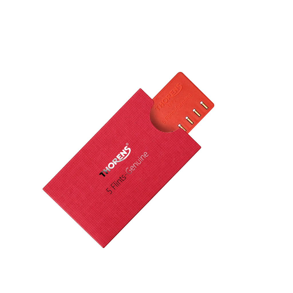 Thorens lighter flint replacement pack partially slid from red textured sleeve, showing five flints aligned in holder on a clean background.
