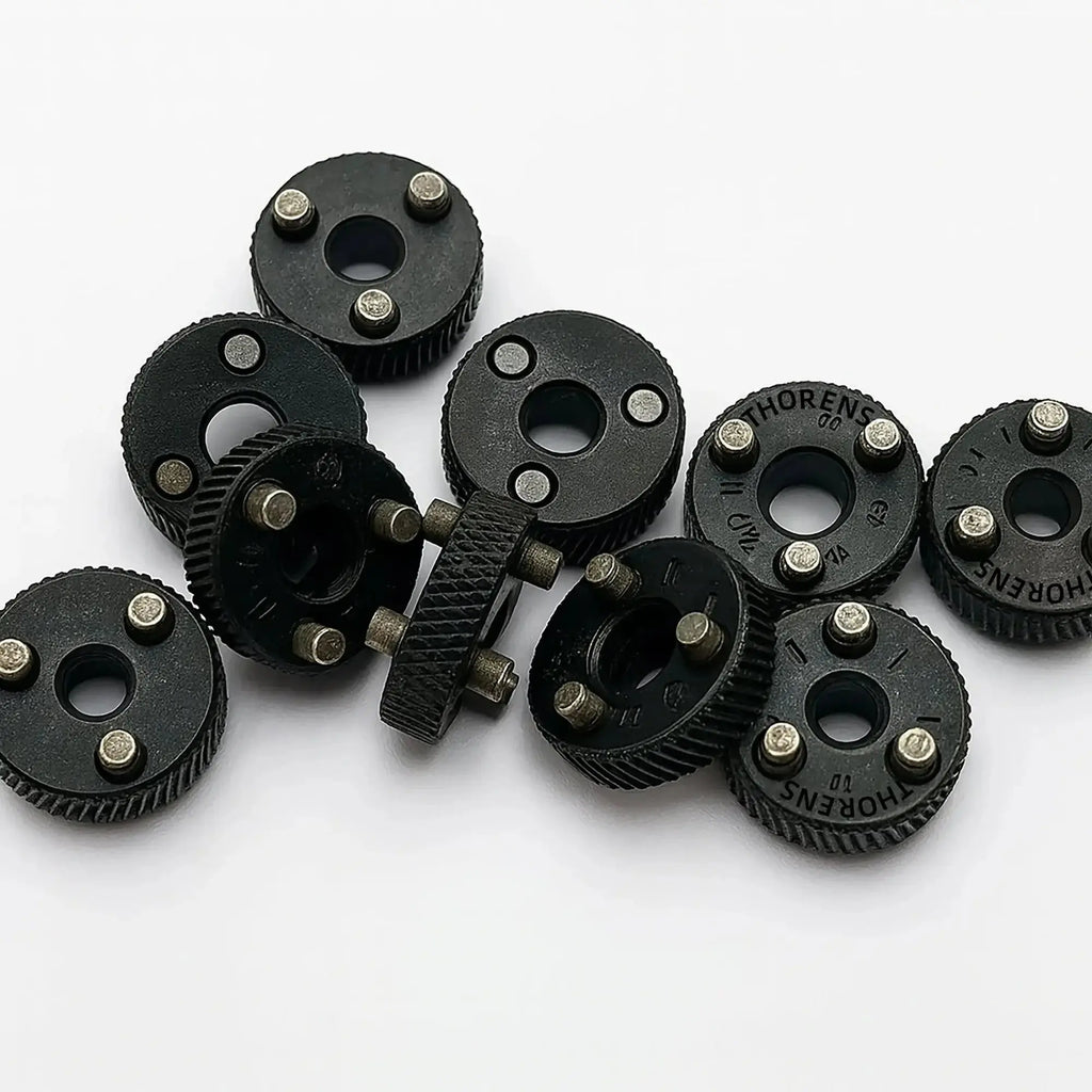 A collection of Thorens lighter flint wheels in a matte black finish, specifically designed for single and double claw mechanical lighters, showcasing the precision-milled gears and mounting pins.