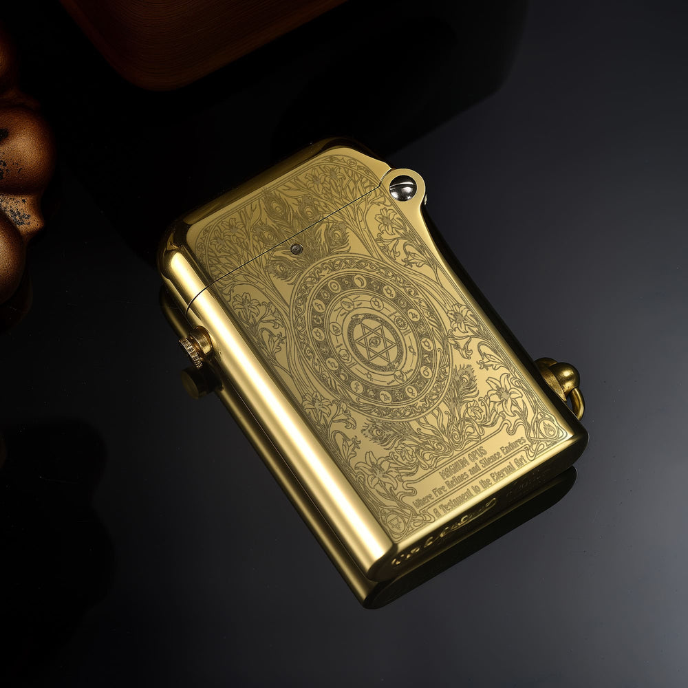 Thorens Magnum Opus lighter in polished brass shown closed, featuring intricate engraved surface patterns and smooth curved edges on a dark reflective background.