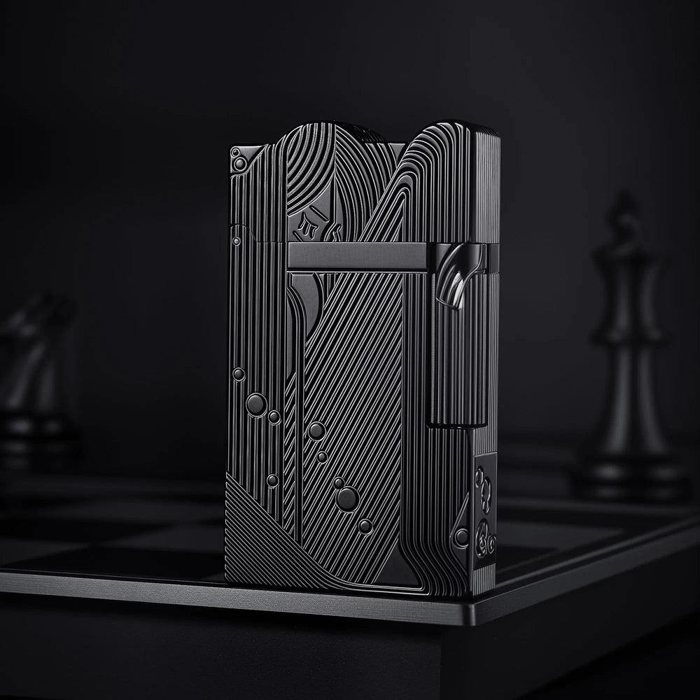 A front-facing view of the black Thorens Mermaid lighter, showcasing the deep-etched Art Deco mermaid motif and unique scalloped top against a dark, moody background.