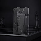 A front-facing view of the black Thorens Mermaid lighter, showcasing the deep-etched Art Deco mermaid motif and unique scalloped top against a dark, moody background.