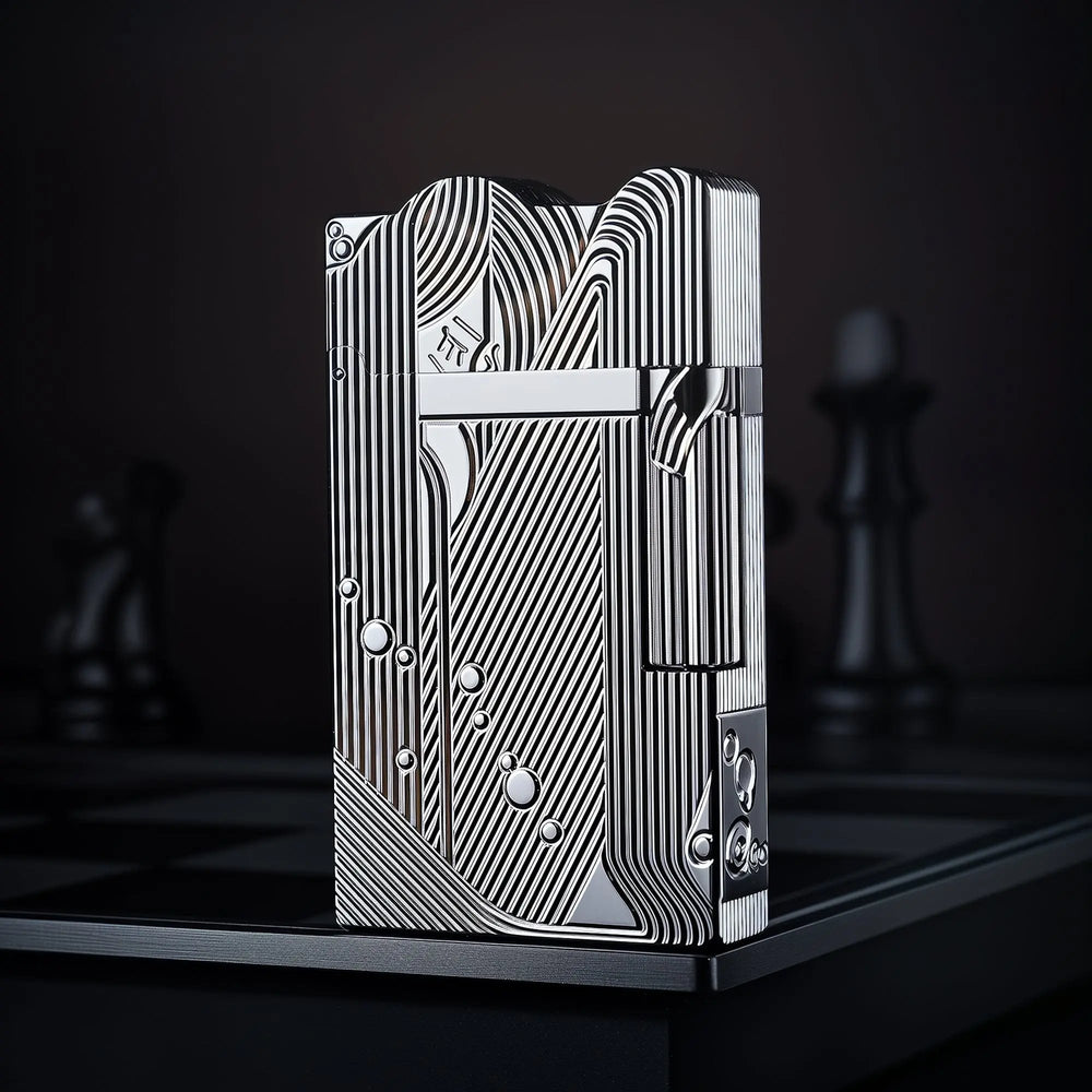A front-profile view of the silver Thorens Mermaid lighter, showcasing the high-luster chrome finish and intricate Art Deco engravings against a dark, dramatic background.