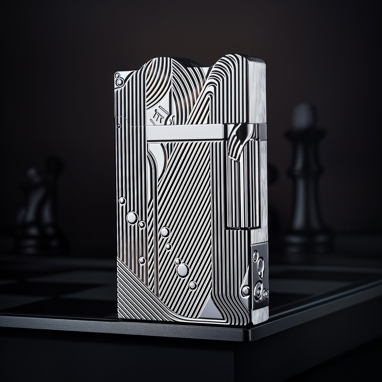 A front-profile view of the silver Thorens Mermaid lighter, showcasing the high-luster chrome finish and intricate Art Deco engravings against a dark, dramatic background.