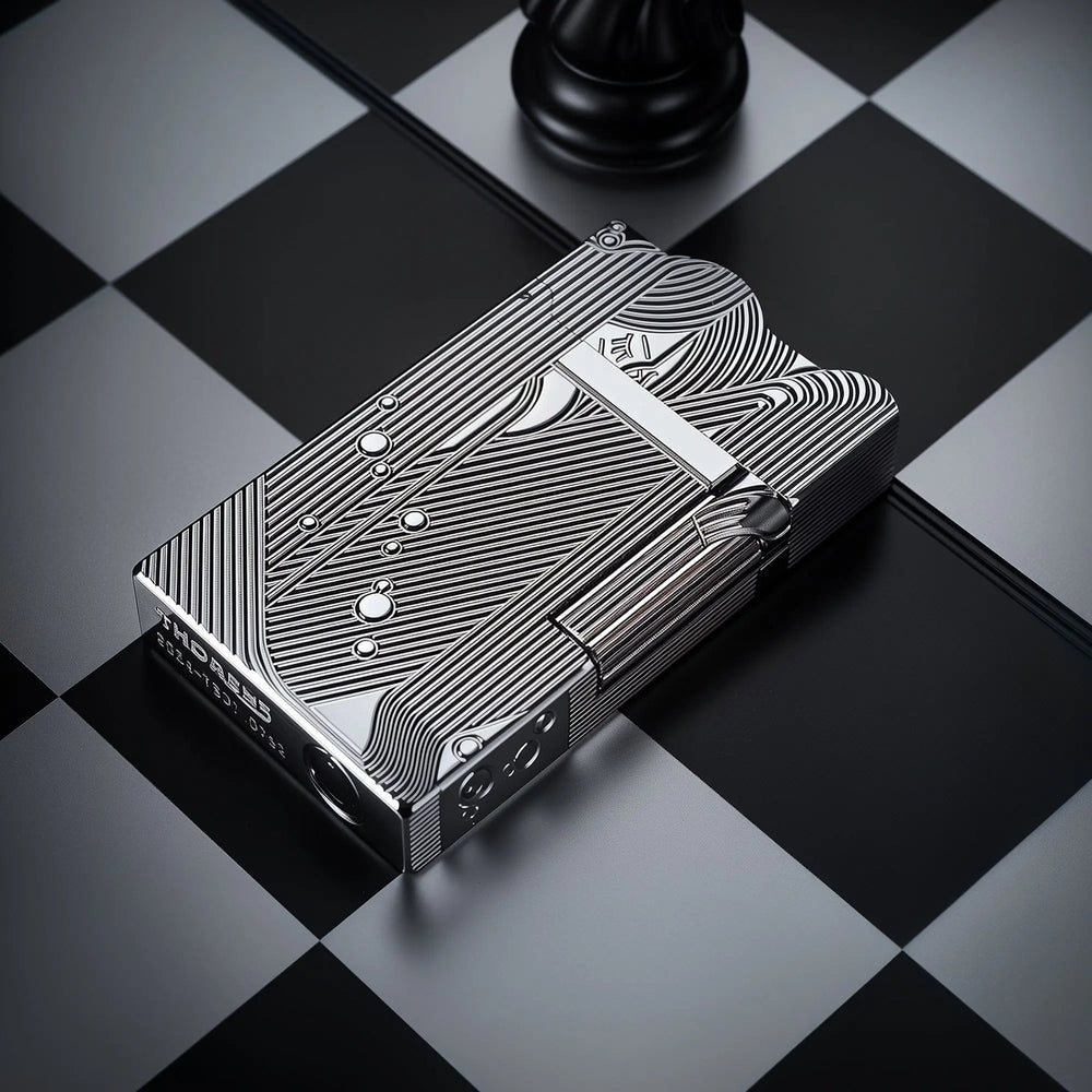 A high-angle perspective of a silver Thorens Mermaid lighter on a chessboard. The cool chrome-like finish highlights the intricate Art Deco mermaid engravings and the unique scalloped lid design.