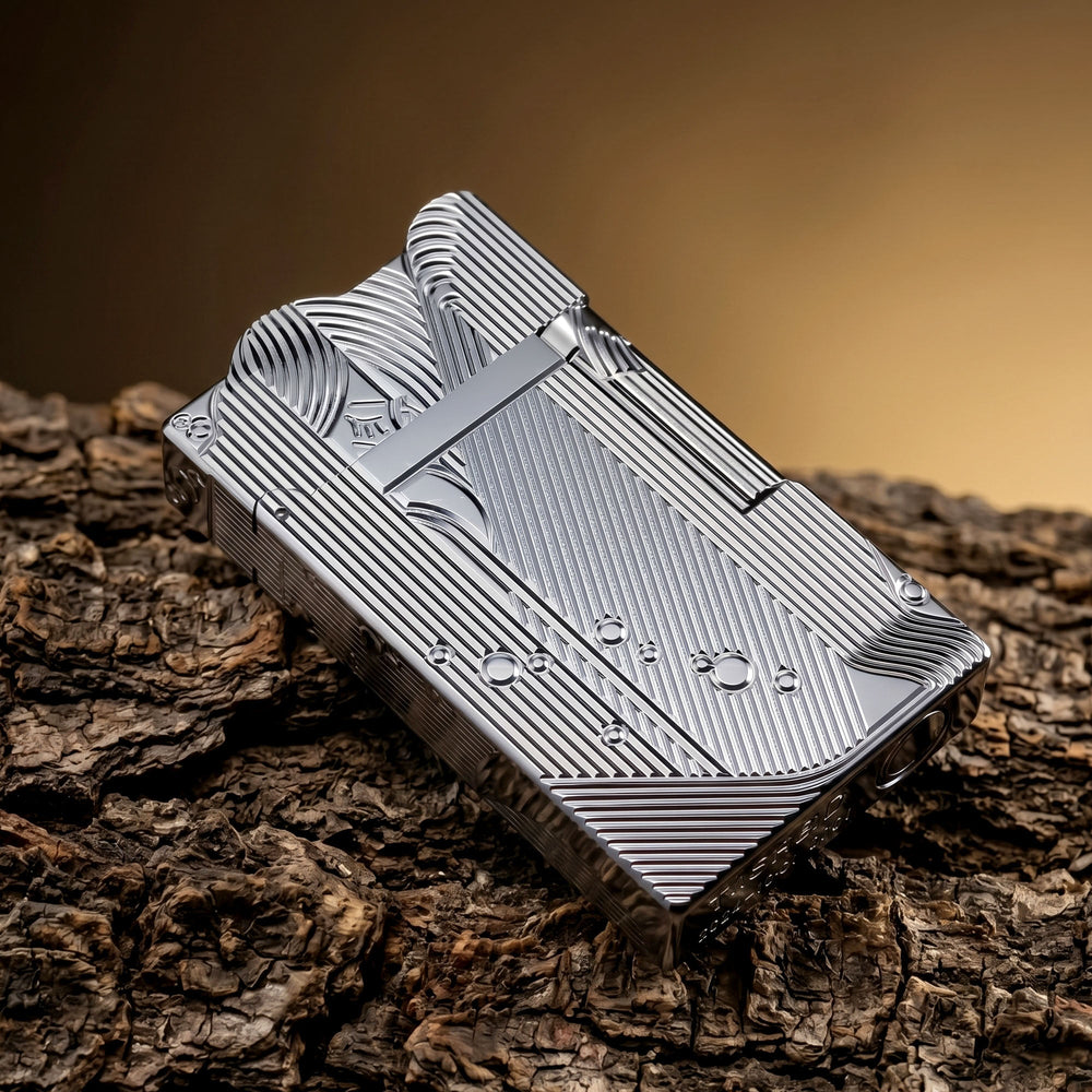 A silver Thorens Mermaid lighter resting on a chessboard, showing the intricate linework on its side panels and the unique scalloped top edge in a bright, metallic finish.