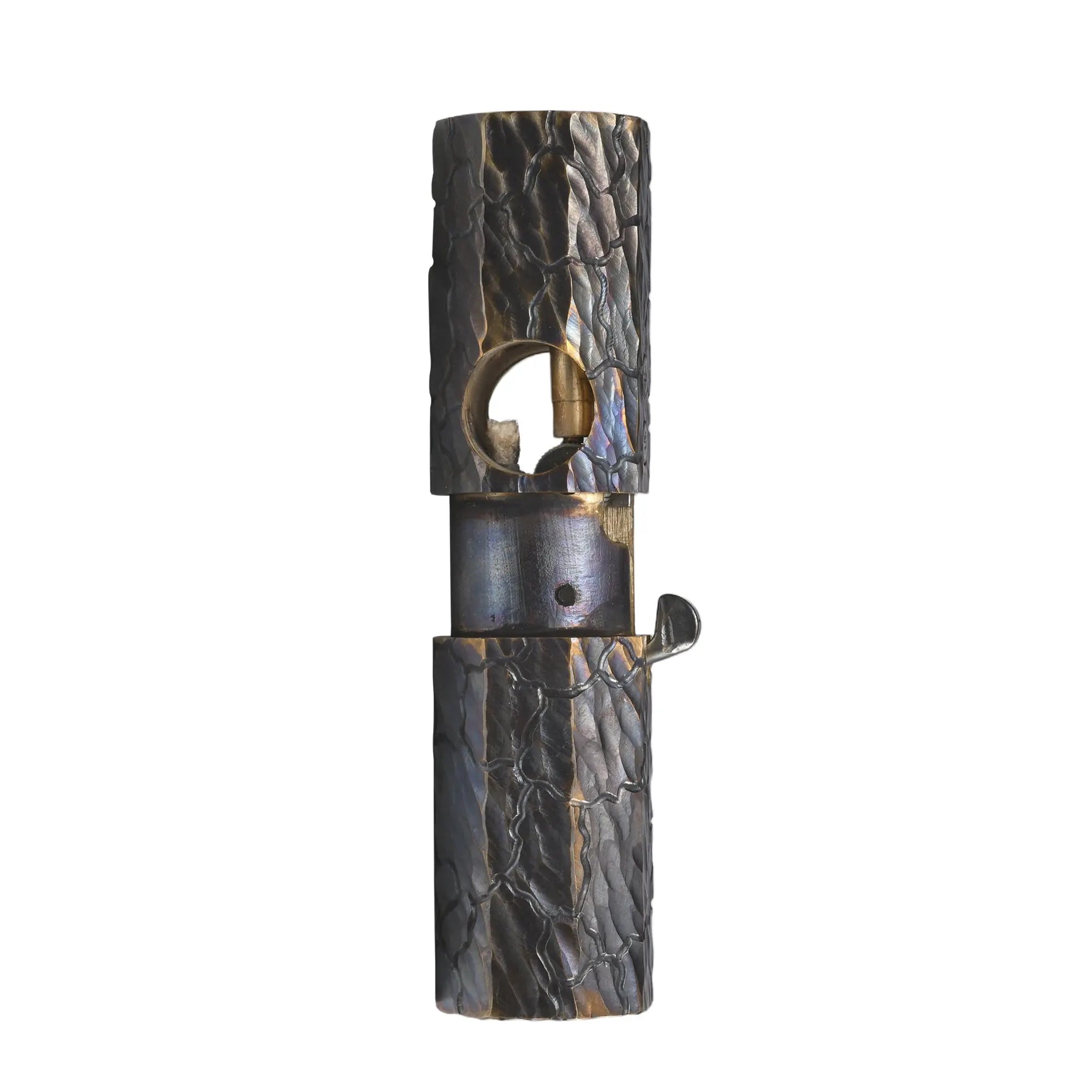 Front view of the Octagon Trigger lighter with its mechanical sleeve raised, revealing the brass ignition port and hand-carved fissure texture.