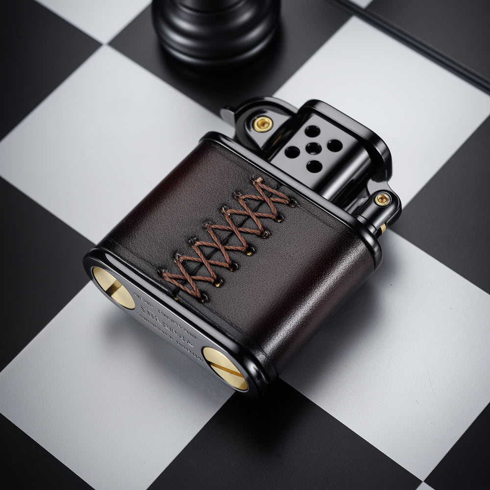Back view of the THORENS handmade cowhide lighter with inlaid mechanical movement in red and black color, showing leather wrap and hand-stitched lace detail.