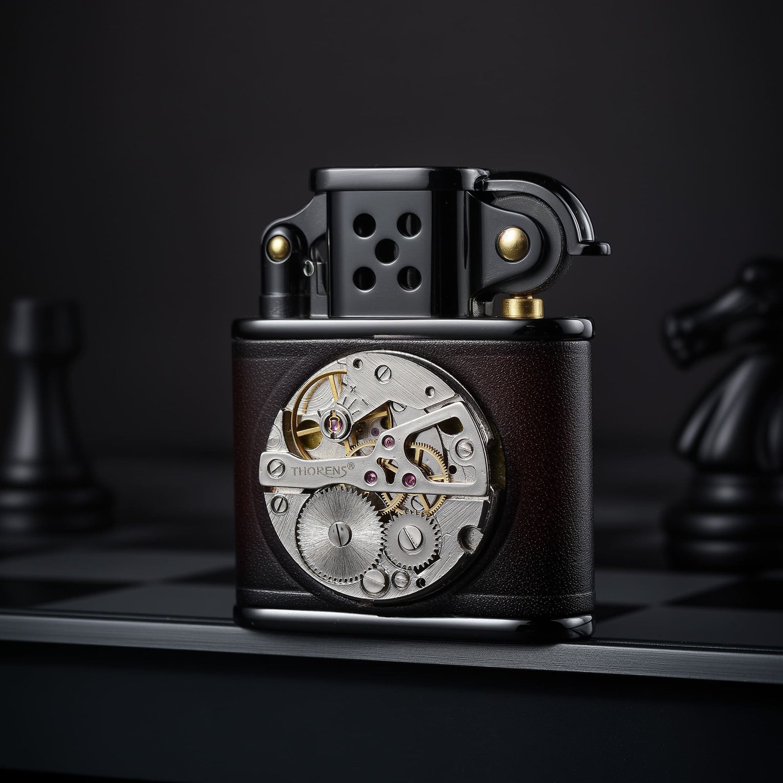 Front view of the THORENS handmade cowhide lighter with inlaid mechanical movement in red and black color, featuring a visible round mechanical movement window on the front.