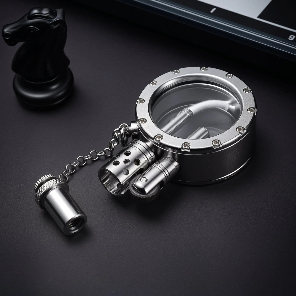 A silver Round Pocket Watch Lighter with the cap removed, revealing the flint wheel and ignition chimney next to a crystal-studded transparent fuel tank.