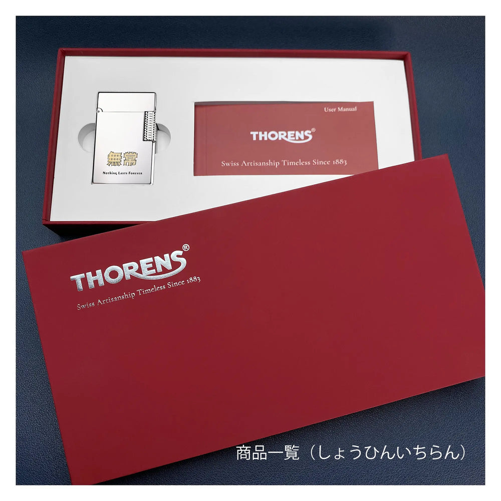 A premium Thorens presentation box in deep red with silver foil branding, featuring a slim silver Side Slip lighter engraved with the Kanji characters "無常" (Anitya/Impermanence) and the quote "Nothing Lasts Forever."