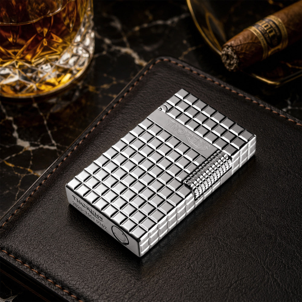 A Thorens Side Slip Argent Blocks lighter presented in its official red gift box, including spare flints, replacement wicks, and a user manual.