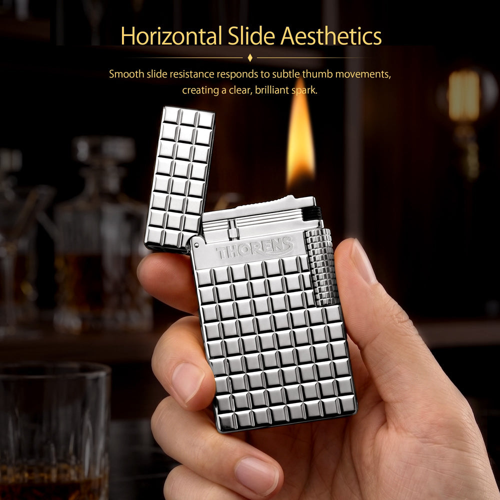 An open silver Thorens side slip lighter showing the internal flint mechanism and polished lid, featuring a high-shine argent blocks pattern and side roller.