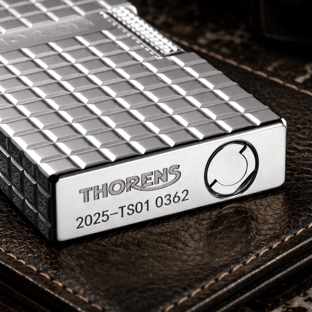 The reverse side of a silver Thorens side slip lighter, displaying the seamless argent block pattern and high-polish finish across the mechanical body.