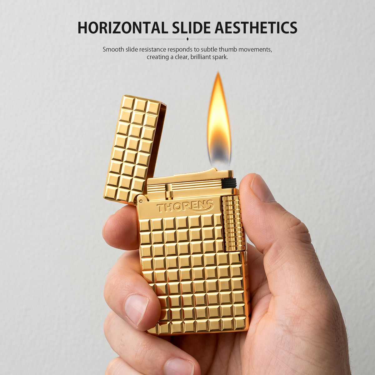 An open gold Thorens side slip lighter featuring a polished auric block pattern, a detailed view of the internal ignition mechanism, and a textured side roller.