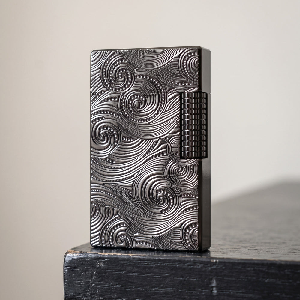 A product detail collage of the black Thorens Side Slip lighter with Vortex engraving, showing the open lid mechanism, the engraved base with serial number, the precision-knurled side-slip flint wheel, and the internal wick housing, showcasing premium mechanical craftsmanship.