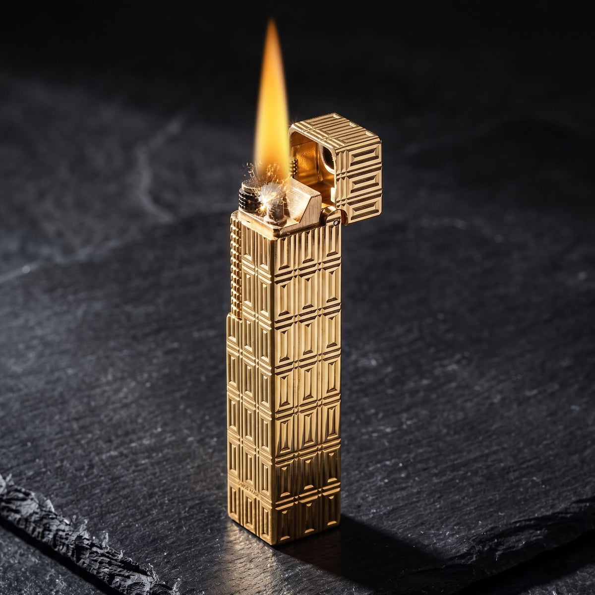 Thorens Side Slip rectangular lighter with geometric block pattern and extended roller igniting with flame and spark, lid open to reveal flint wheel and wick on brass body.