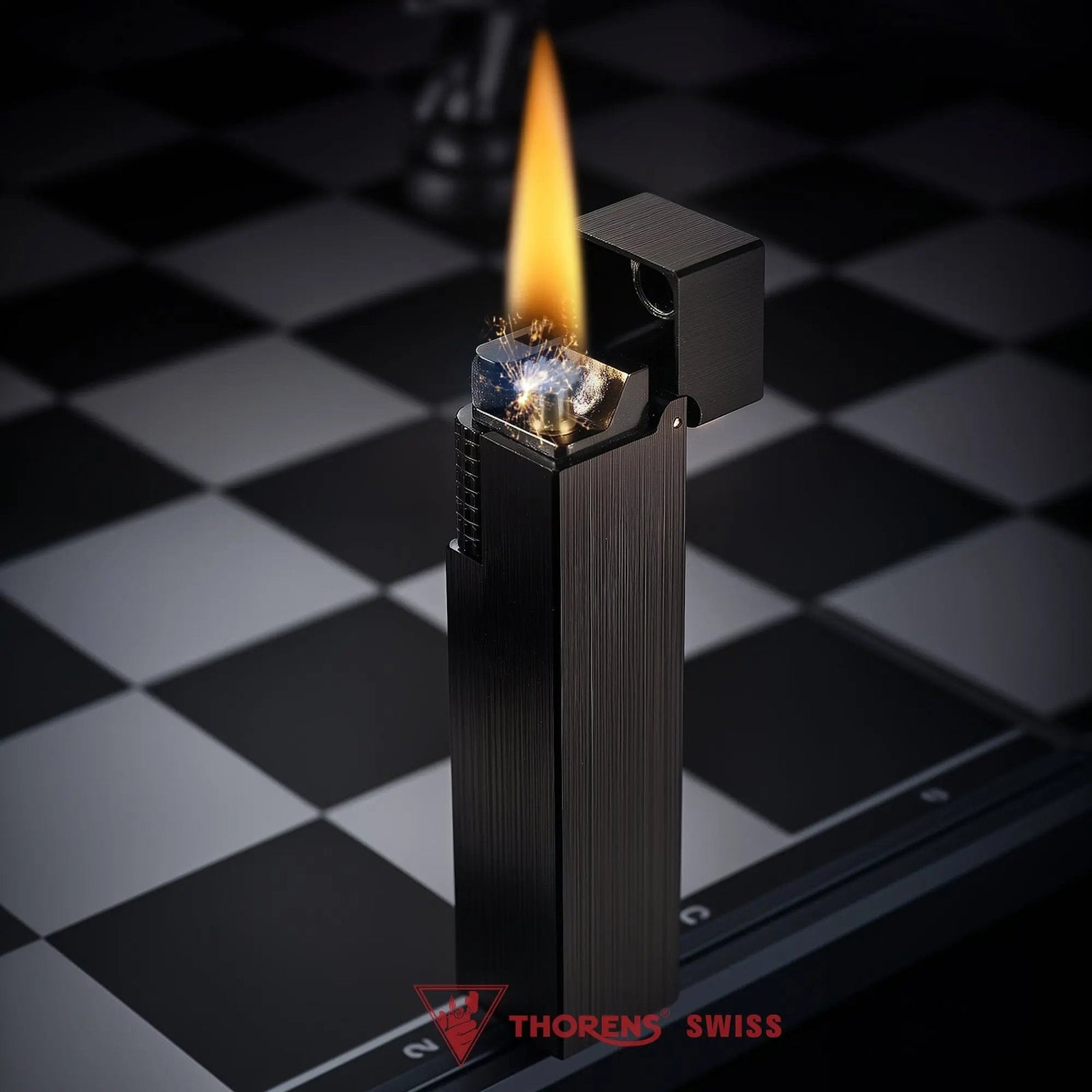 A vertical shot of the Side Slip Glossy Black rectangular lighter with its lid open, standing ignited with a flame and sparks on a chessboard.