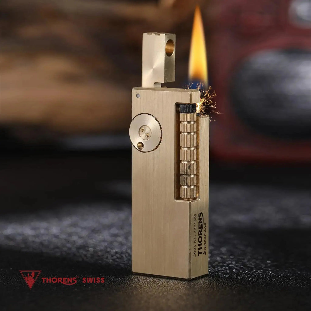 A Thorens Side Slip glossy brass lighter shown in mid-ignition, featuring sparks and a steady flame to demonstrate its reliable mechanical precision and high-end EDC functionality.