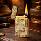 A premium gold Thorens Side Slip lighter with an intricate Vortex engraved pattern, shown standing open with a steady flame against a refined study backdrop, highlighting its heritage brass craftsmanship and collectible aesthetic.