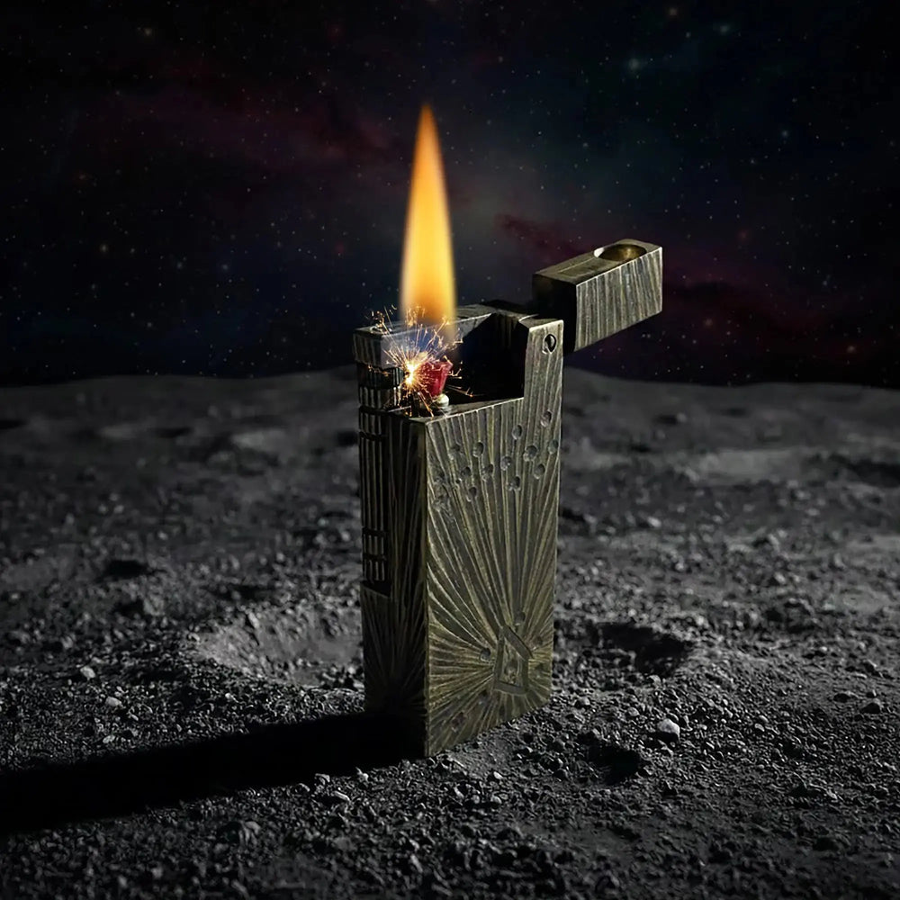 A Thorens Side Slip lighter in the Meteorite Crater antique brass finish, shown ignited against a lunar-themed background to highlight its rugged mechanical reliability and celestial-inspired design.