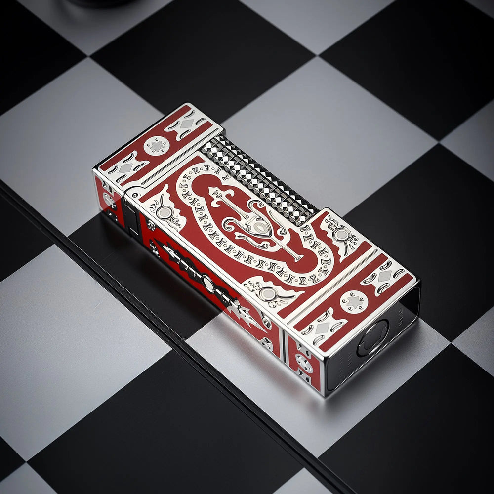 A Side Slip narrow lighter featuring the red Holy Grail pattern and intricate silver engravings, placed horizontally on a black and white checkered surface.