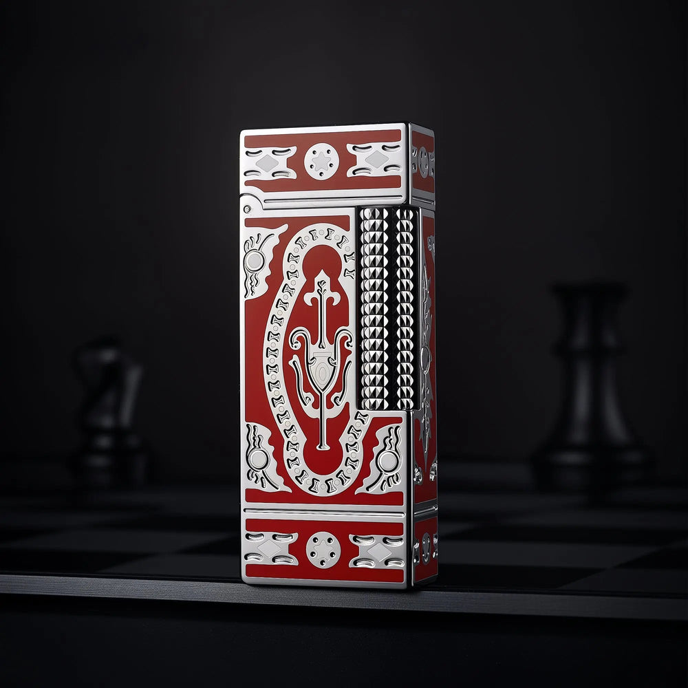 A vertical shot of the Thorens Side Slip narrow lighter in red, showcasing the silver Holy Grail engravings and textured flint wheel against a dark, moody backdrop.