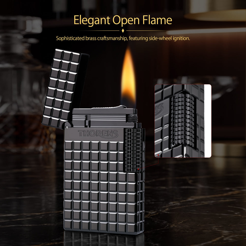 An open Thorens side slip lighter in matte onyx black, showing an active flame and flint sparks against the textured block pattern and side roller.