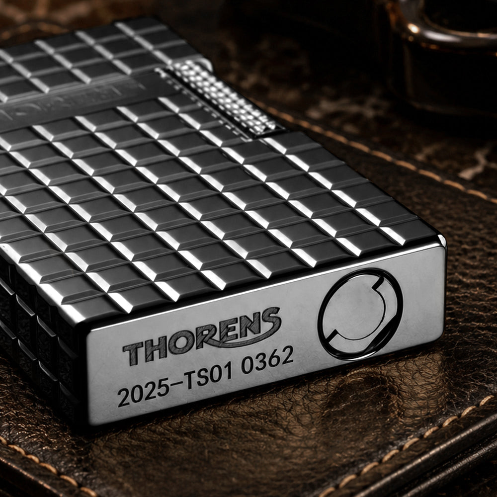 The back of an onyx black Thorens side slip lighter, showcasing the continuous matte block pattern and refined mechanical construction.