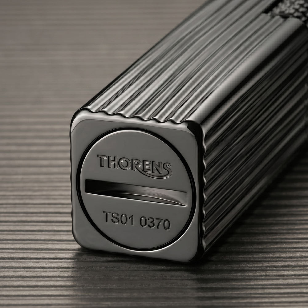 Thorens Side Slip rectangular lighter in black pinstripe finish showing engraved base plate with fuel slot and precision metal construction.