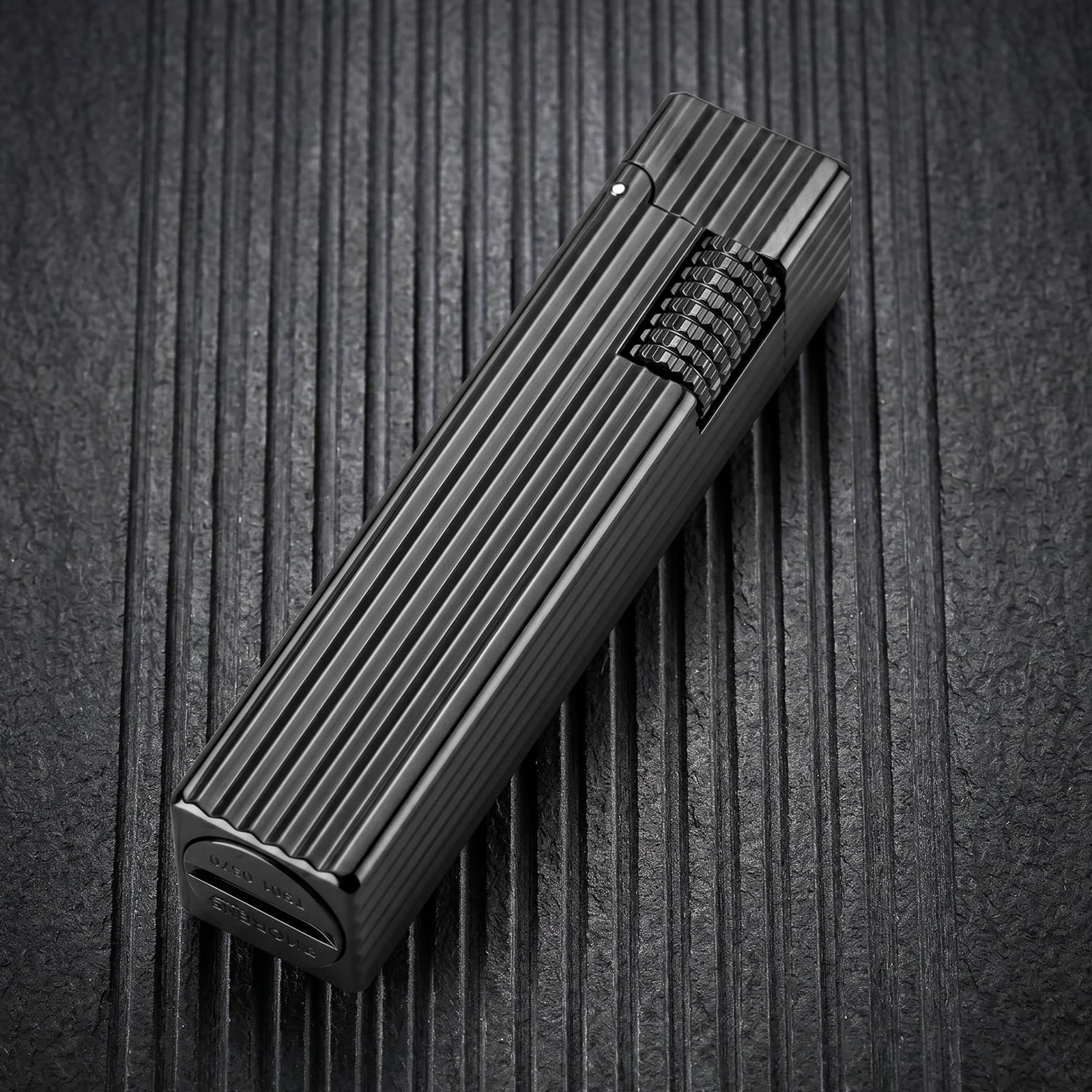 Thorens Side Slip rectangular lighter in black pinstripe finish shown closed, highlighting textured side ignition wheel and linear brushed metal body.