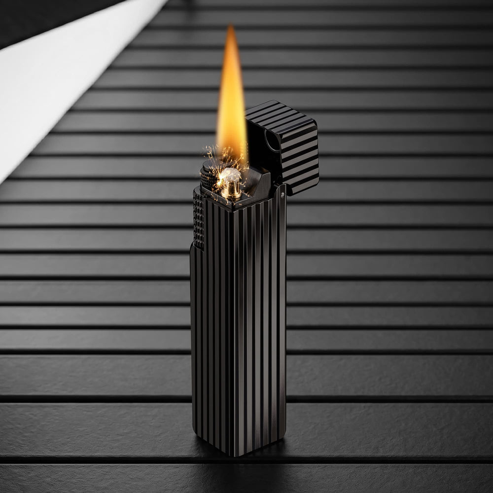 Thorens Side Slip rectangular lighter in black pinstripe finish igniting with visible spark and flame, lid open to reveal precision ignition mechanism.
