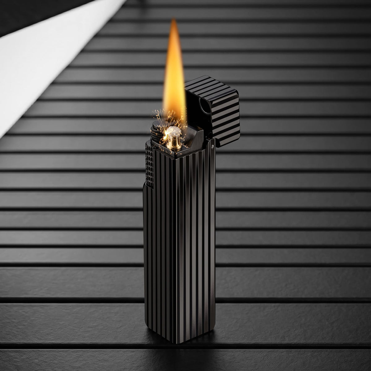Thorens Side Slip rectangular lighter in black pinstripe finish igniting with visible spark and flame, lid open to reveal precision ignition mechanism.