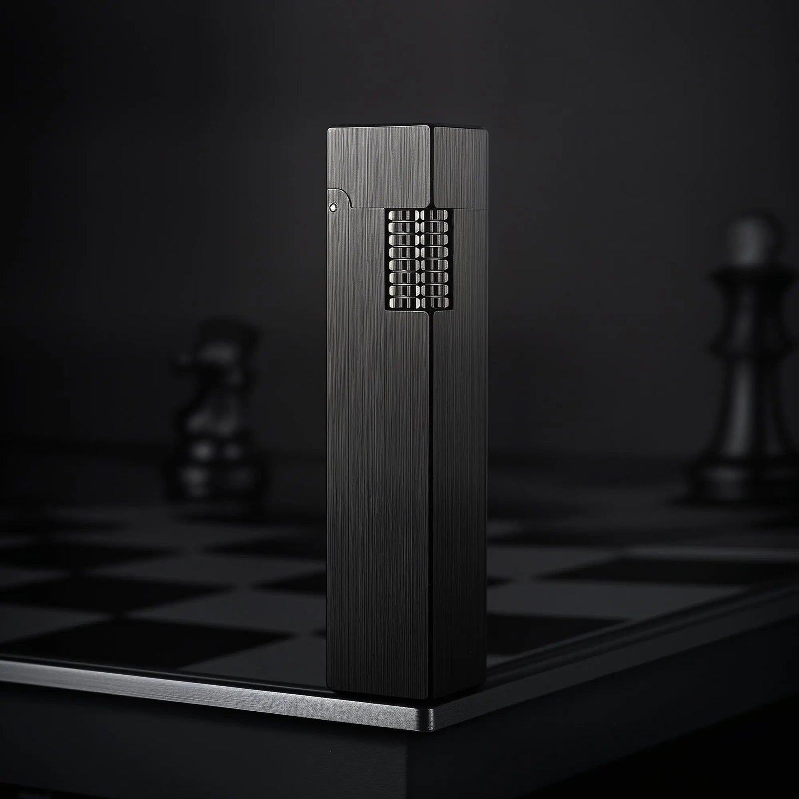 A vertical shot of the Side Slip Glossy Black rectangular lighter with a sleek vertical-textured finish, standing on a dark chessboard.
