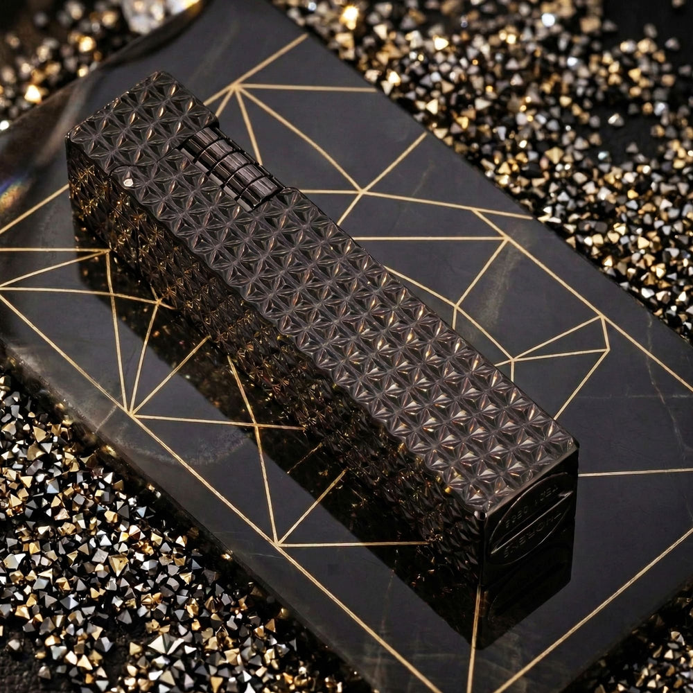 Thorens Side Slip rectangular lighter in black starburst pattern resting on a geometric surface, highlighting textured engraving and integrated ignition wheel.