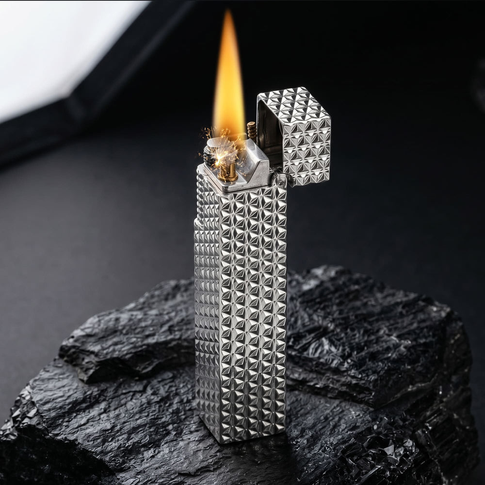 Thorens Side Slip rectangular lighter in silver starburst pattern igniting with visible spark and flame, lid open to reveal precision ignition mechanism.