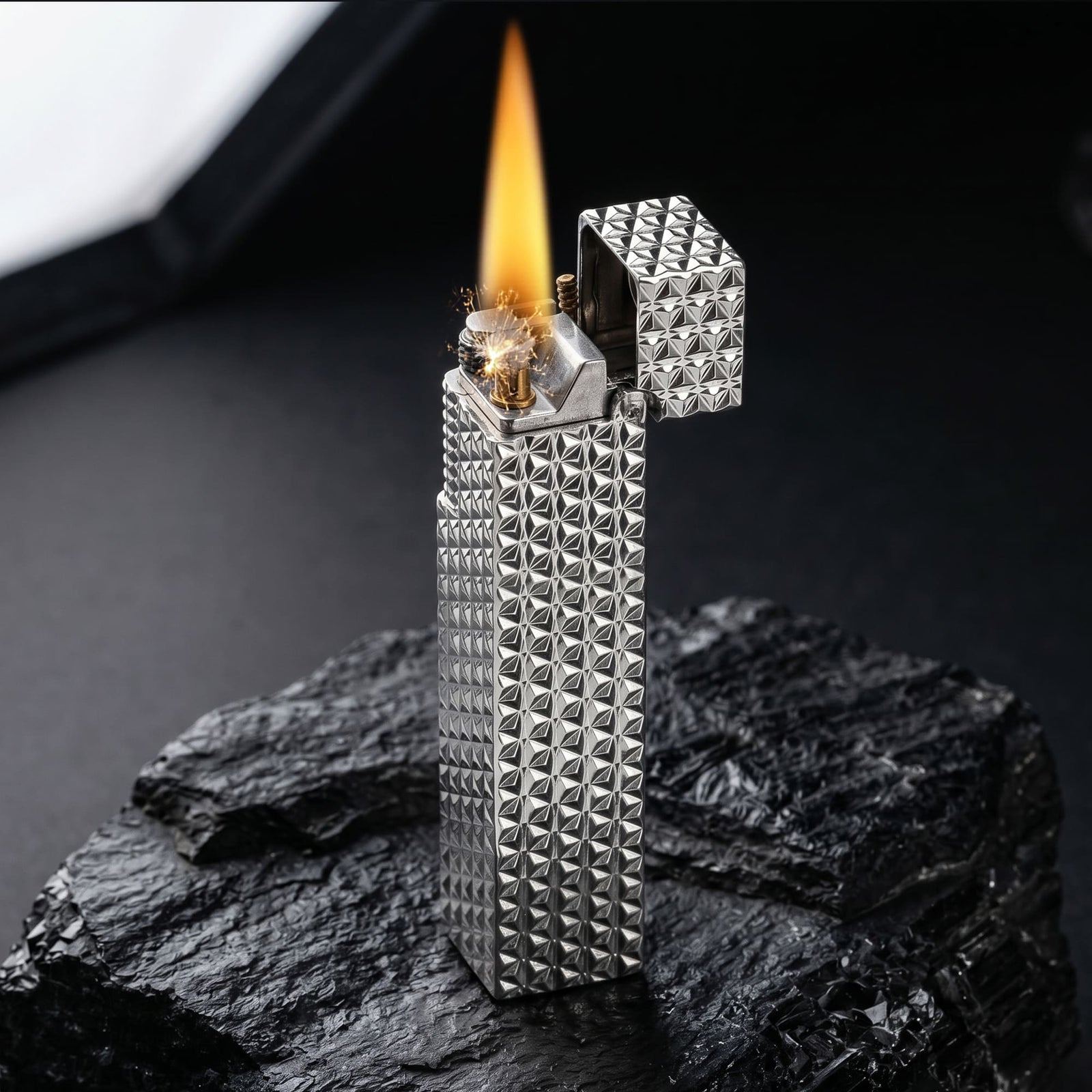 Thorens Side Slip rectangular lighter in silver starburst pattern igniting with visible spark and flame, lid open to reveal precision ignition mechanism.