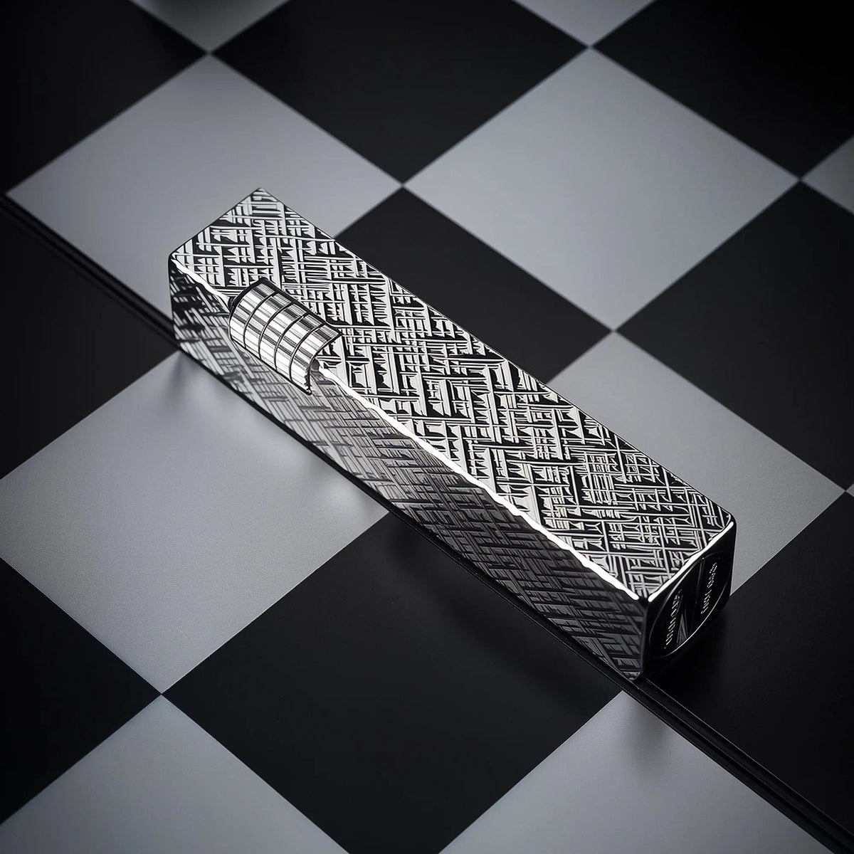 Silver carved Thorens rectangular side-slip lighter with an engraved geometric texture and exposed ignition wheel, placed diagonally on a black and white checkered surface