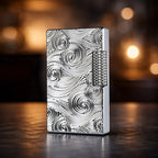 A close-up view of a premium silver Thorens side-slip lighter featuring an intricate, deeply carved vortex pattern on its brass body, showcased on a wooden surface.