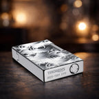 A cinematic low-angle shot of the "Vortex" engraved silver Side Slip lighter, showcasing the high-polish base with deep-etched "THORENS" branding and unique 2025-TS01 serial number. The atmospheric lighting highlights the fluid, swirling textures and the precision-milled fuel fill port.