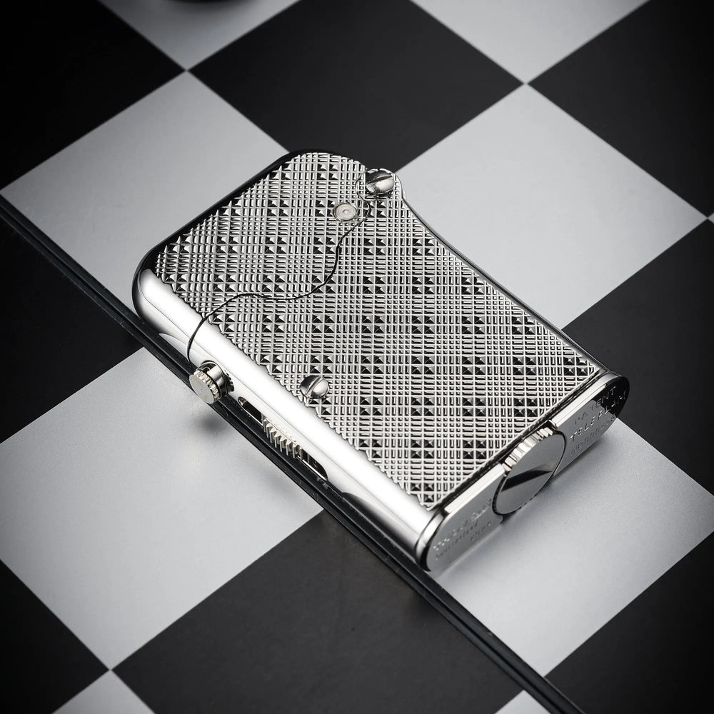 Close-up view of the Thorens Single Claw Teleflam lighter with its plum pattern texture and mechanical flint mechanism, resting on a checkerboard.