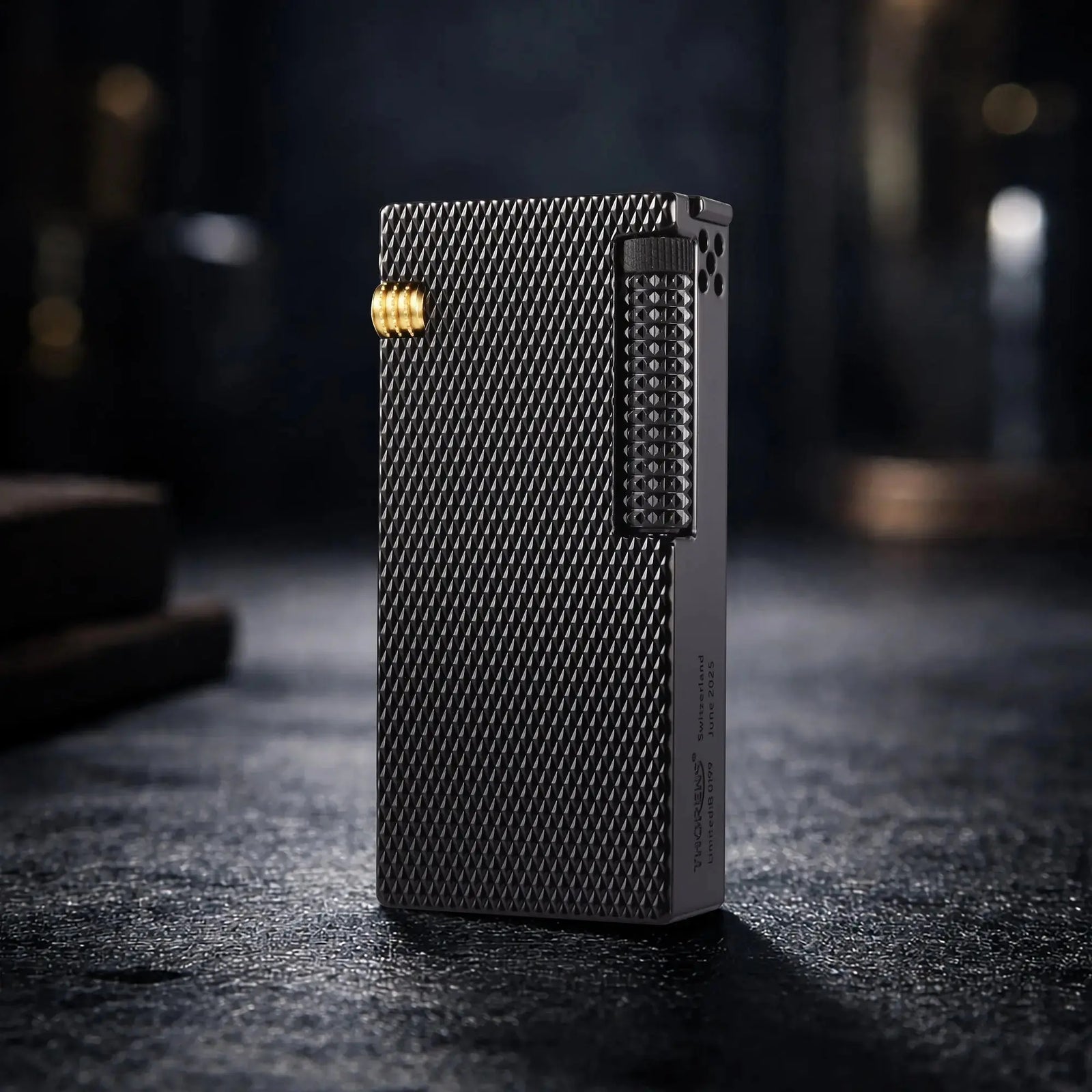 A professional still life shot of the Thorens Slim Cube lighter in Black Mesh finish, standing on a textured dark surface. The image highlights the intricate diamond-patterned mesh texture, gold-toned mechanical accents, and the limited edition "Thorens Switzerland" engraving on the side, reflecting a premium EDC aesthetic.