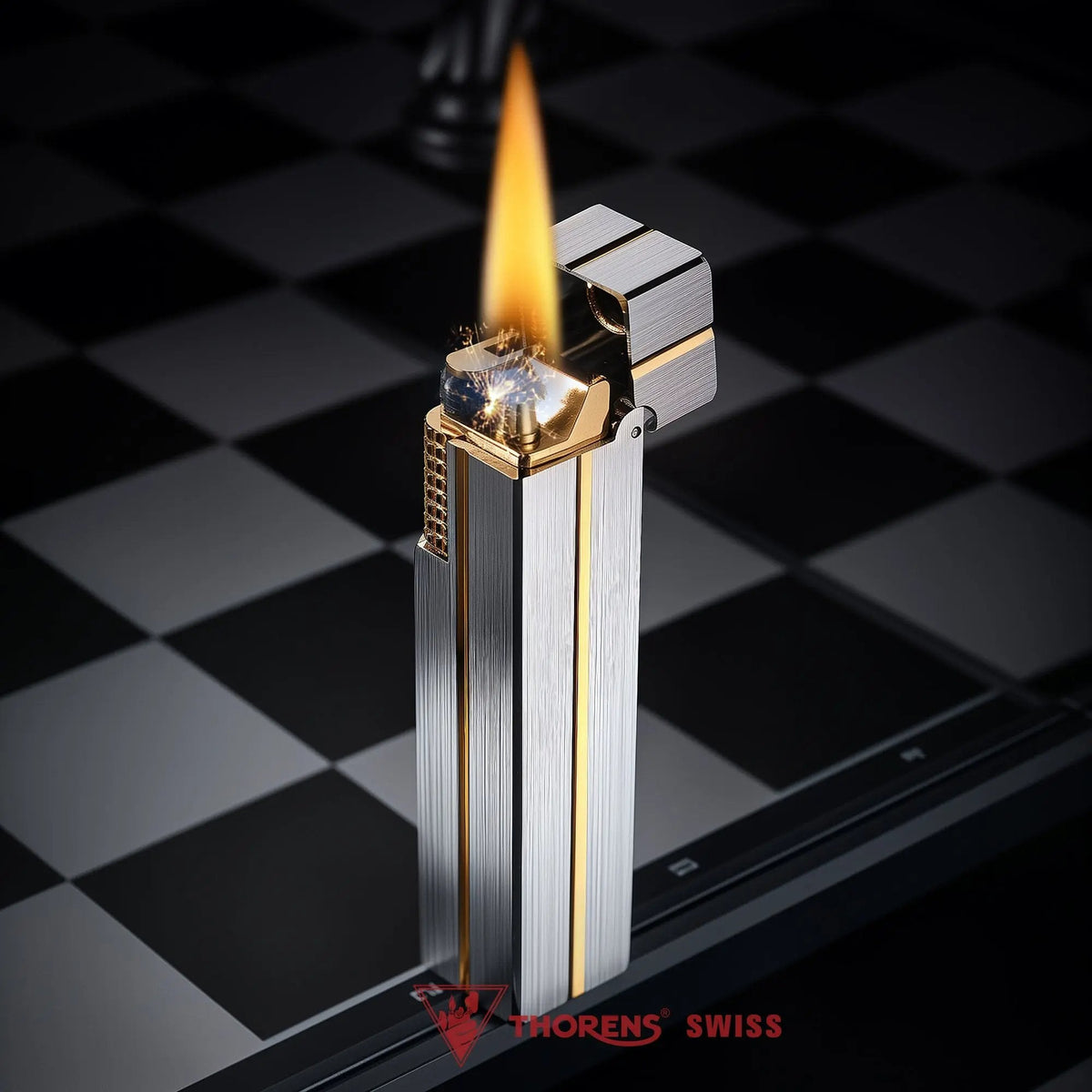 A vertical Side Slip Star Shine rectangular lighter with a silver brushed finish and gold accents, standing open and ignited with a steady flame and sparks.