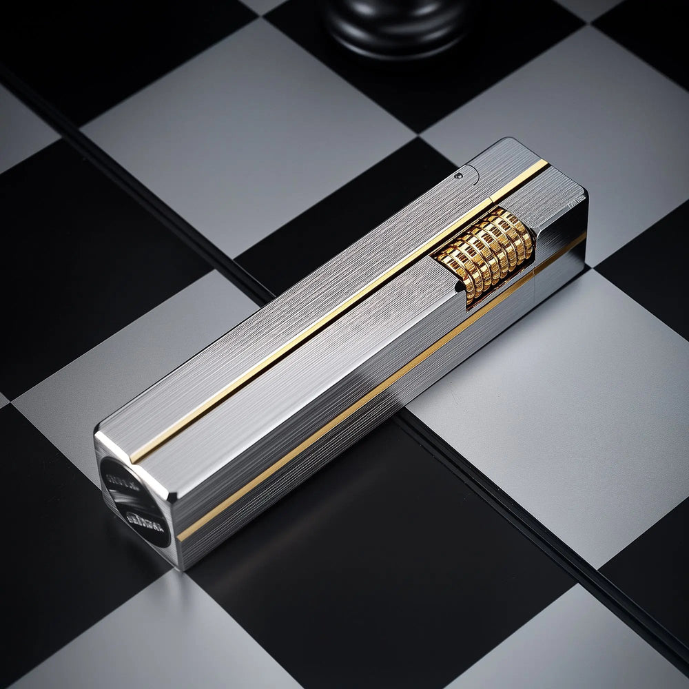 A rectangular Side Slip Star Shine lighter with a textured silver finish and gold-tone accents resting on a black and white checkered surface.