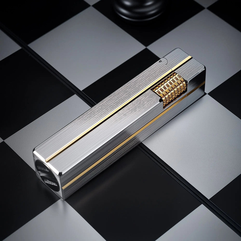 A rectangular Side Slip Star Shine lighter with a textured silver finish and gold-tone accents resting on a black and white checkered surface.