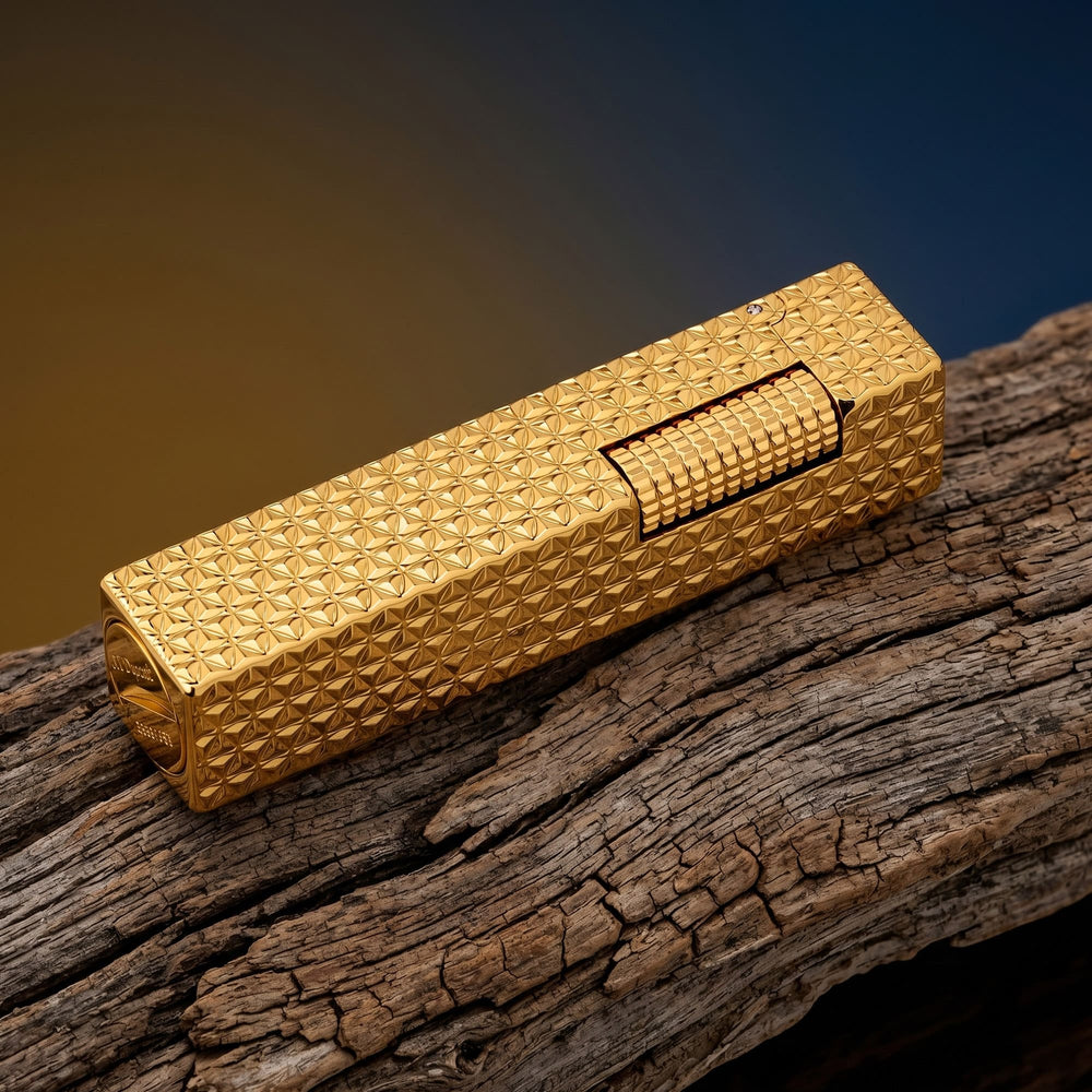 Thorens rectangular lighter with gold starburst pattern and extended roller shown closed, highlighting engraved brass texture and precision side-slide ignition wheel.